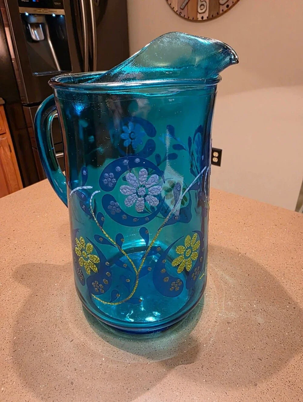 Vintage turquoise Libbey glass pitcher with painted design.